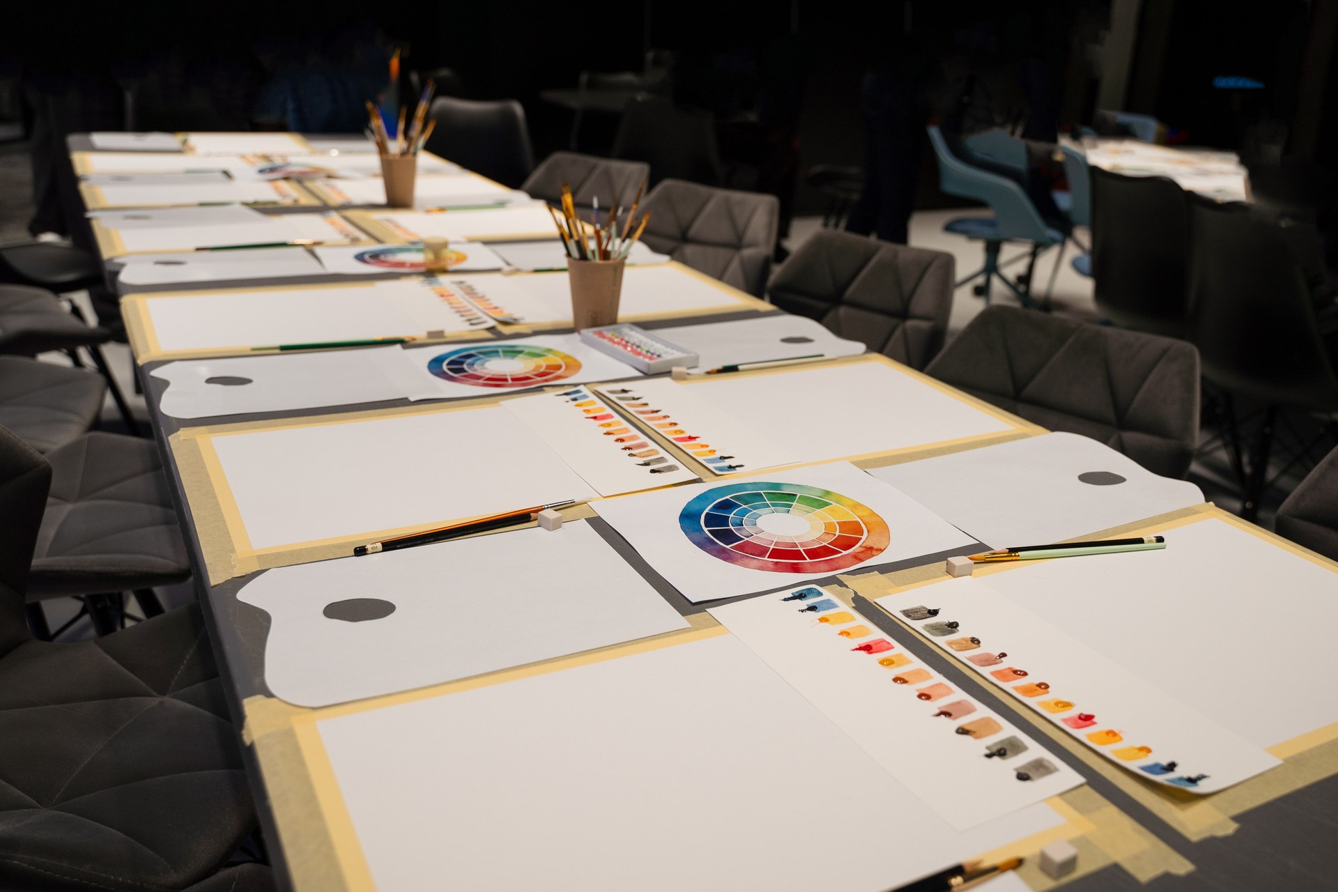 Art palette with watercolor paints and paintbrushes prepared for art masterclass. Organizing art workspace for artists experiments with colors.